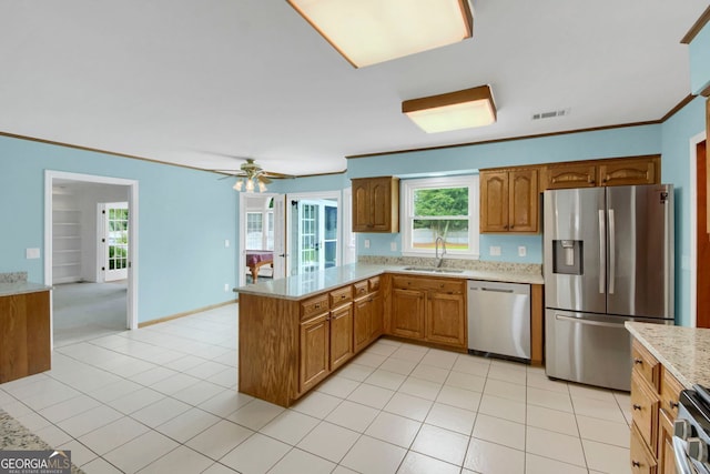 1197 Kenilworth Trce, Snellville, GA 30078 - kitchen featuring stainless steel appliances, a peninsula, light stone countertops, light tile patterned flooring, and ceiling fan