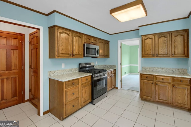 1197 Kenilworth Trce, Snellville, GA 30078 - kitchen with stainless steel appliances, brown cabinetry, ornamental molding, light stone counters, and light tile patterned floors