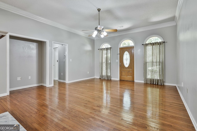 77 Springfield Ct, Newnan, GA 30265 - foyer with ceiling fan, hardwood / wood-style floors, crown molding, and a textured ceiling