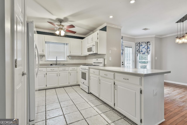 77 Springfield Ct, Newnan, GA 30265 - kitchen featuring white appliances, a peninsula, crown molding, a ceiling fan, and healthy amount of natural light