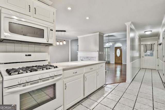 77 Springfield Ct, Newnan, GA 30265 - kitchen featuring white appliances, ornamental molding, a ceiling fan, light tile patterned flooring, and white cabinetry
