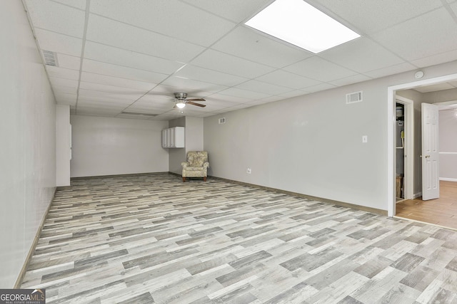 77 Springfield Ct, Newnan, GA 30265 - basement with light wood-type flooring, a paneled ceiling, and ceiling fan