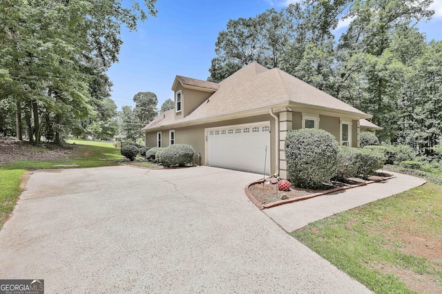 77 Springfield Ct, Newnan, GA 30265 - view of side of property with stucco siding, driveway, an attached garage, and roof with shingles