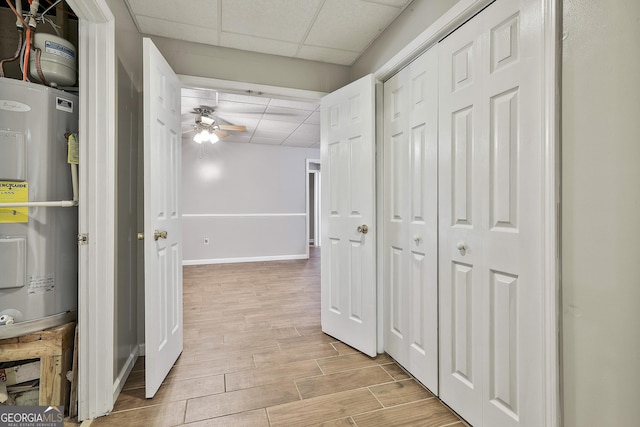 77 Springfield Ct, Newnan, GA 30265 - corridor featuring water heater, a drop ceiling, and light wood-style floors