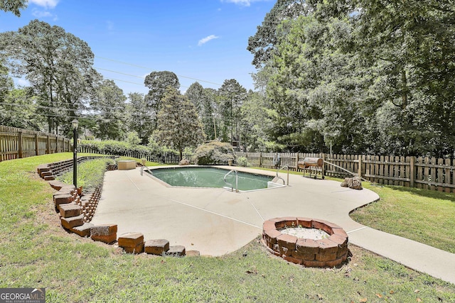 77 Springfield Ct, Newnan, GA 30265 - view of swimming pool featuring a fire pit, a patio, a fenced backyard, and view of scattered trees