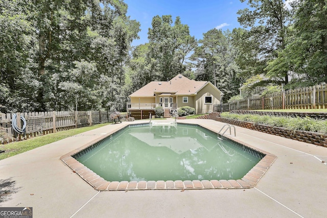 77 Springfield Ct, Newnan, GA 30265 - view of swimming pool featuring a deck, a fenced backyard, and view of scattered trees