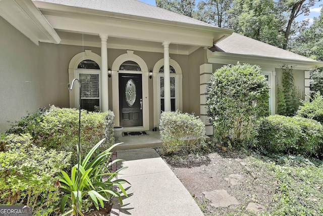 77 Springfield Ct, Newnan, GA 30265 - view of exterior entry featuring stucco siding and a shingled roof
