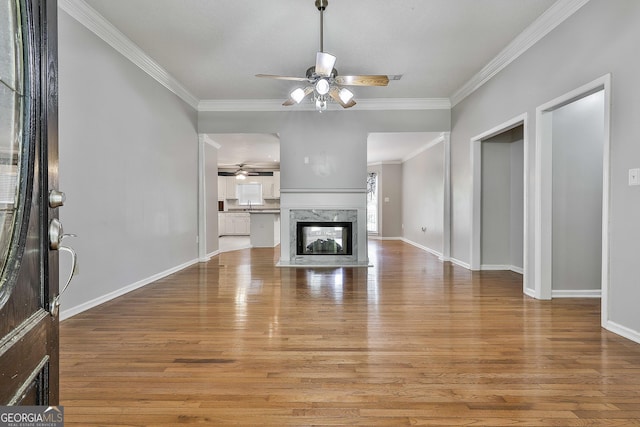 77 Springfield Ct, Newnan, GA 30265 - unfurnished living room featuring ceiling fan, light wood-style flooring, crown molding, and a fireplace