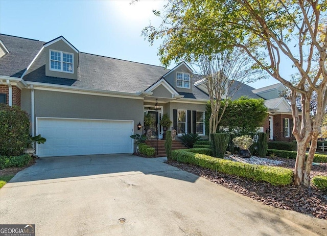 133 N Wellington, Macon, GA 31210 - view of front facade with concrete driveway, a garage, stucco siding, and a shingled roof