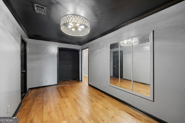 133 N Wellington, Macon, GA 31210 - unfurnished room with a chandelier, crown molding, and wood finished floors