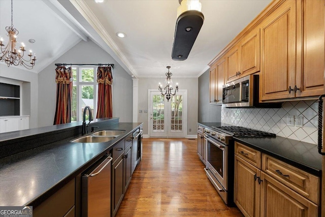 133 N Wellington, Macon, GA 31210 - kitchen featuring a chandelier, stainless steel appliances, dark countertops, wood finished floors, and ornamental molding