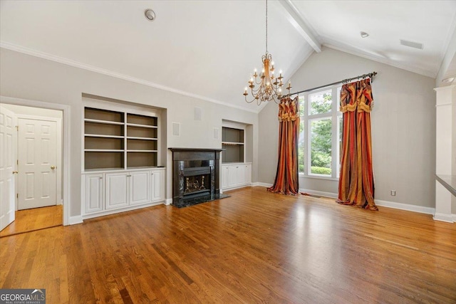 133 N Wellington, Macon, GA 31210 - unfurnished living room with a chandelier, wood finished floors, built in shelves, a high end fireplace, and crown molding