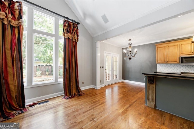 133 N Wellington, Macon, GA 31210 - kitchen with stainless steel microwave, a chandelier, tasteful backsplash, ornamental molding, and light wood finished floors