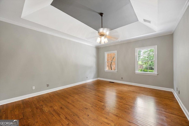 133 N Wellington, Macon, GA 31210 - unfurnished room with a tray ceiling, ornamental molding, wood finished floors, and a ceiling fan