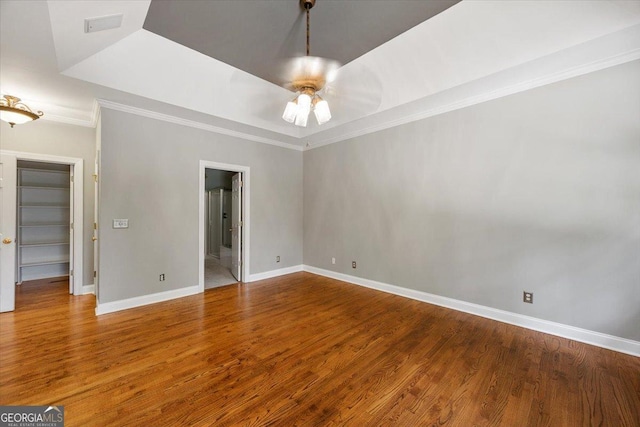 133 N Wellington, Macon, GA 31210 - unfurnished bedroom with crown molding, wood finished floors, a tray ceiling, connected bathroom, and ceiling fan