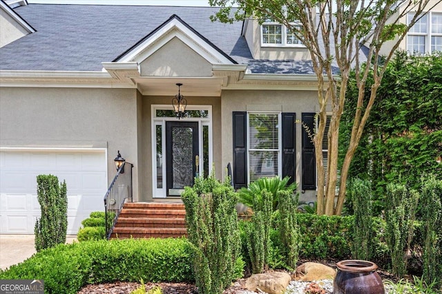 133 N Wellington, Macon, GA 31210 - property entrance featuring a garage, stucco siding, and a shingled roof