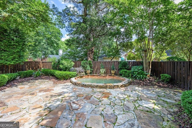 133 N Wellington, Macon, GA 31210 - fenced backyard featuring an in-ground hot tub and a patio area