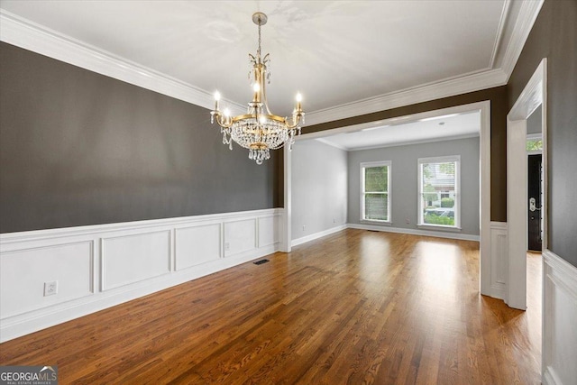 133 N Wellington, Macon, GA 31210 - spare room featuring a chandelier, wood finished floors, crown molding, wainscoting, and a decorative wall