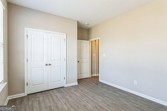110 Golden Ingot Ct, Perry, GA 31069 - unfurnished bedroom featuring wood finished floors and a closet