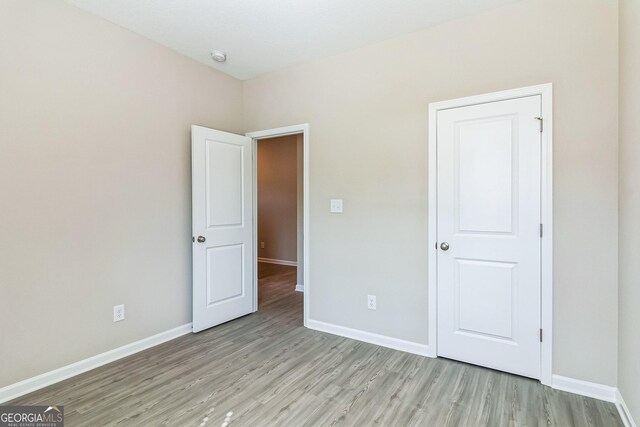 110 Golden Ingot Ct, Perry, GA 31069 - unfurnished bedroom featuring light wood-type flooring and baseboards