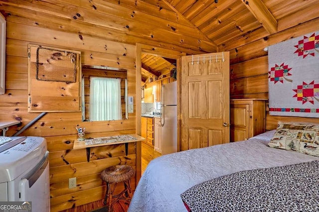 41 Wilderness Ct, Blairsville, GA 30512 - bedroom featuring wood ceiling, freestanding refrigerator, vaulted ceiling, wooden walls, and washing machine and dryer