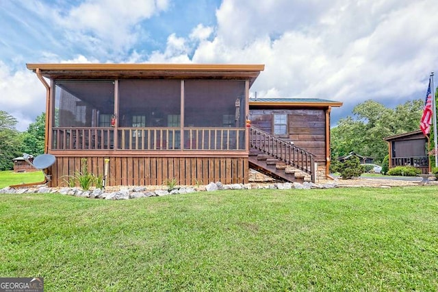 41 Wilderness Ct, Blairsville, GA 30512 - view of front of house with a sunroom, a front lawn, and stairs