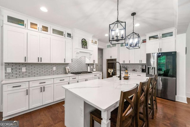 213 River Trl, Ball Ground, GA 30107 - kitchen with stainless steel appliances, a chandelier, white cabinets, tasteful backsplash, and hanging light fixtures