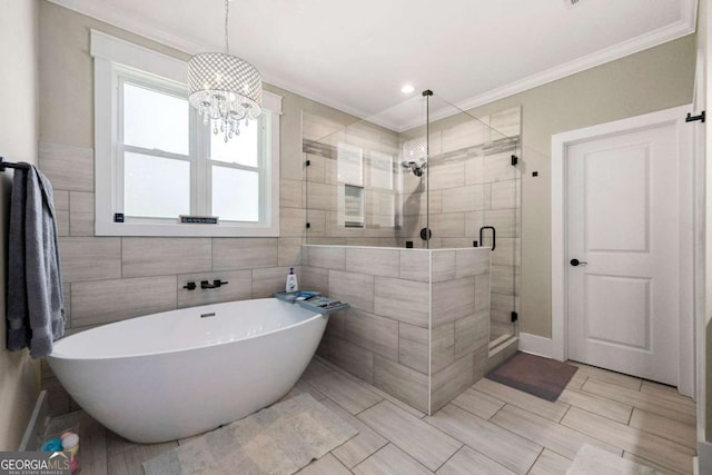 213 River Trl, Ball Ground, GA 30107 - full bath featuring a freestanding bath, ornamental molding, a stall shower, a chandelier, and tile walls
