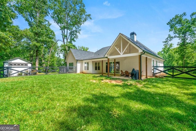 213 River Trl, Ball Ground, GA 30107 - back of house with a gate, a fenced backyard, a chimney, and a patio