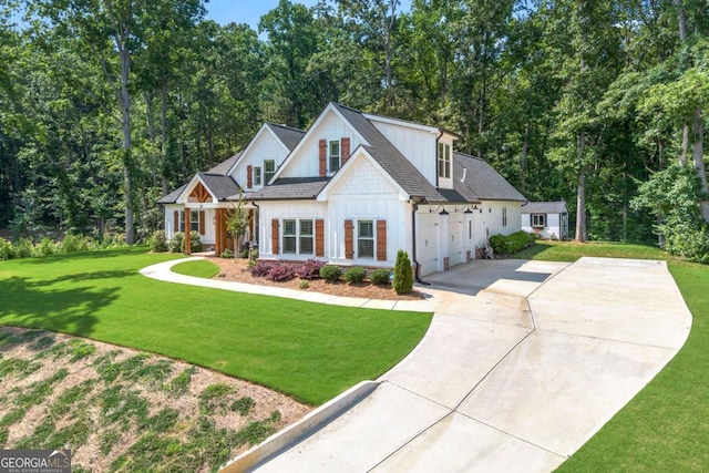 213 River Trl, Ball Ground, GA 30107 - modern inspired farmhouse featuring concrete driveway, a front yard, an attached garage, roof with shingles, and board and batten siding
