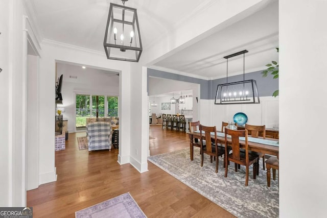 213 River Trl, Ball Ground, GA 30107 - dining room featuring a chandelier, ornamental molding, and wood finished floors