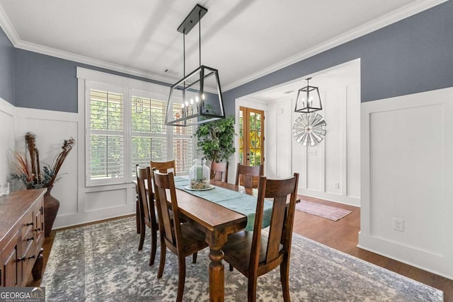 213 River Trl, Ball Ground, GA 30107 - dining space with a chandelier, a decorative wall, plenty of natural light, dark wood-style flooring, and ornamental molding