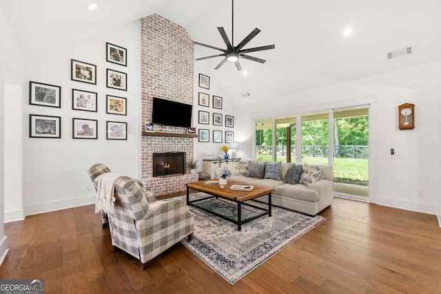 213 River Trl, Ball Ground, GA 30107 - living area with high vaulted ceiling, ceiling fan, a brick fireplace, dark wood-type flooring, and recessed lighting