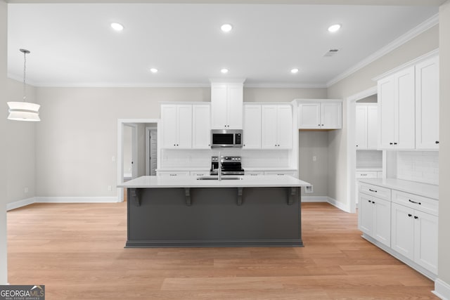 19 Honeysuckle Dr, Claxton, GA 30417 - kitchen featuring appliances with stainless steel finishes, tasteful backsplash, white cabinetry, light countertops, and ornamental molding