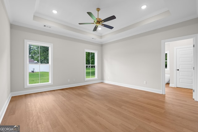 19 Honeysuckle Dr, Claxton, GA 30417 - empty room with a raised ceiling, crown molding, healthy amount of natural light, a ceiling fan, and light wood finished floors