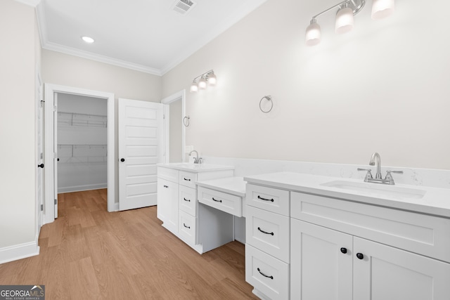 19 Honeysuckle Dr, Claxton, GA 30417 - bathroom featuring vanity, crown molding, wood finished floors, and a spacious closet