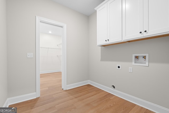 19 Honeysuckle Dr, Claxton, GA 30417 - laundry room featuring electric dryer hookup, hookup for a washing machine, cabinet space, and light wood-style flooring