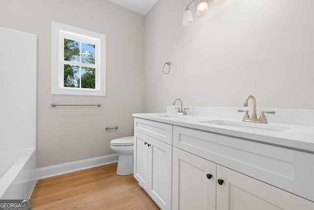 19 Honeysuckle Dr, Claxton, GA 30417 - full bathroom with double vanity, wood finished floors, and a tub