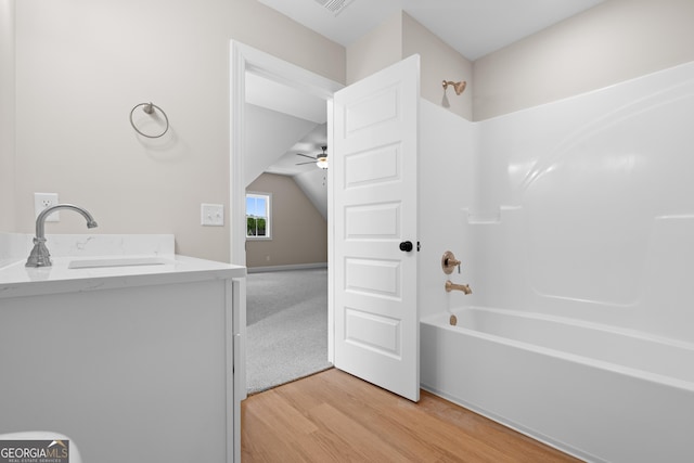 19 Honeysuckle Dr, Claxton, GA 30417 - full bathroom with wood finished floors, a ceiling fan, bathtub / shower combination, vaulted ceiling, and vanity