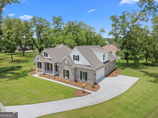 19 Honeysuckle Dr, Claxton, GA 30417 - view of front facade featuring a porch, concrete driveway, stone siding, and a front lawn