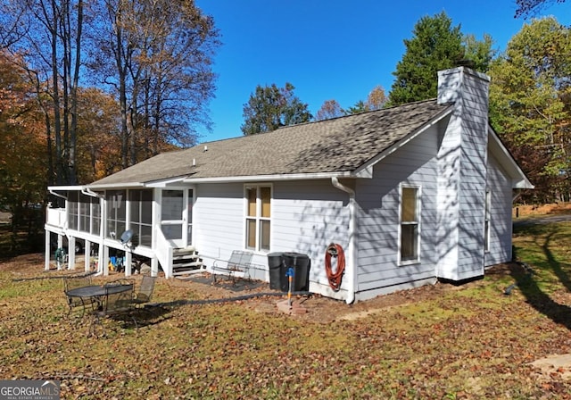104 Bowers Cir, Blairsville, GA 30512 - back of house with a sunroom, a chimney, and roof with shingles