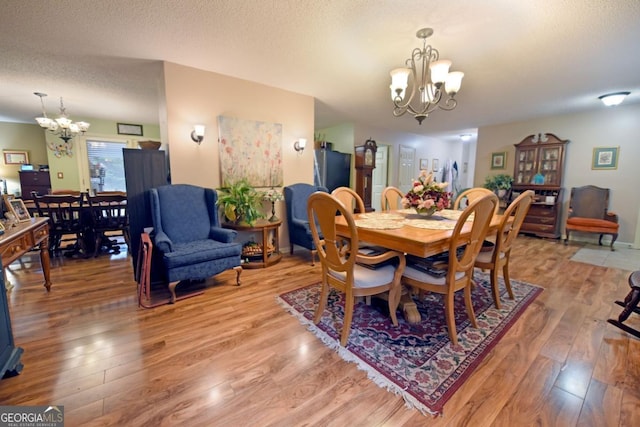 104 Bowers Cir, Blairsville, GA 30512 - dining area with a chandelier, light wood-style floors, and a textured ceiling