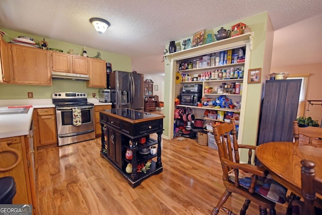 104 Bowers Cir, Blairsville, GA 30512 - kitchen with appliances with stainless steel finishes, under cabinet range hood, open shelves, light countertops, and light wood-style flooring