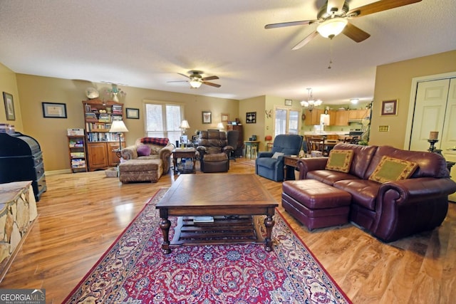 104 Bowers Cir, Blairsville, GA 30512 - living room with ceiling fan, plenty of natural light, light wood-style floors, and a chandelier