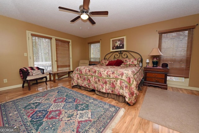 104 Bowers Cir, Blairsville, GA 30512 - bedroom featuring wood finished floors, access to exterior, a ceiling fan, and a textured ceiling