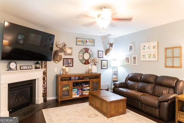 6695 Grove Meadows Ln, Cumming, GA 30028 - living area with a ceiling fan, dark wood-style flooring, and a glass covered fireplace