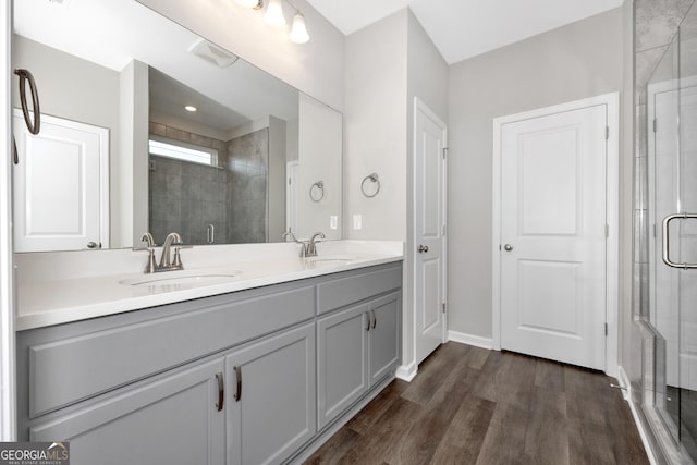 103 Gnome Ct, Perry, GA 31069 - bathroom with a stall shower, double vanity, and wood finished floors