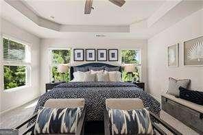 42 Buckingham Ln Unit 233, Hoschton, GA 30548 - bedroom featuring a tray ceiling and ceiling fan