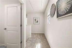 42 Buckingham Ln Unit 233, Hoschton, GA 30548 - corridor with attic access and baseboards