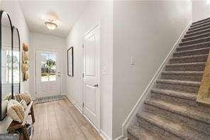42 Buckingham Ln Unit 233, Hoschton, GA 30548 - hall featuring wood finished floors and stairs
